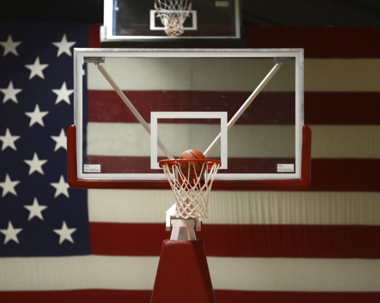 A basketball enters a net