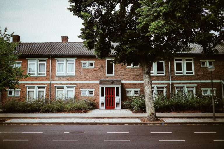 frontage of a concrete building with brickwall