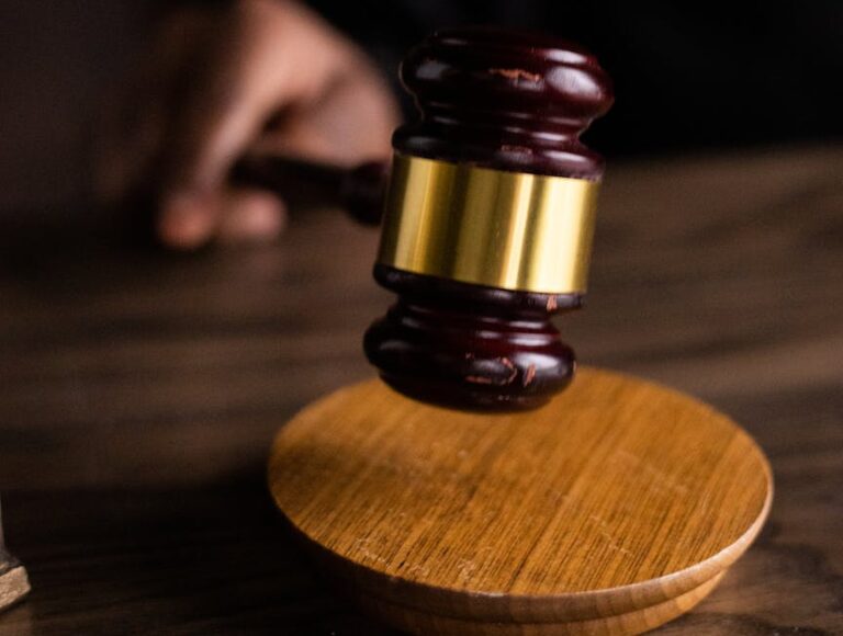brown and gold gavel on brown wooden table