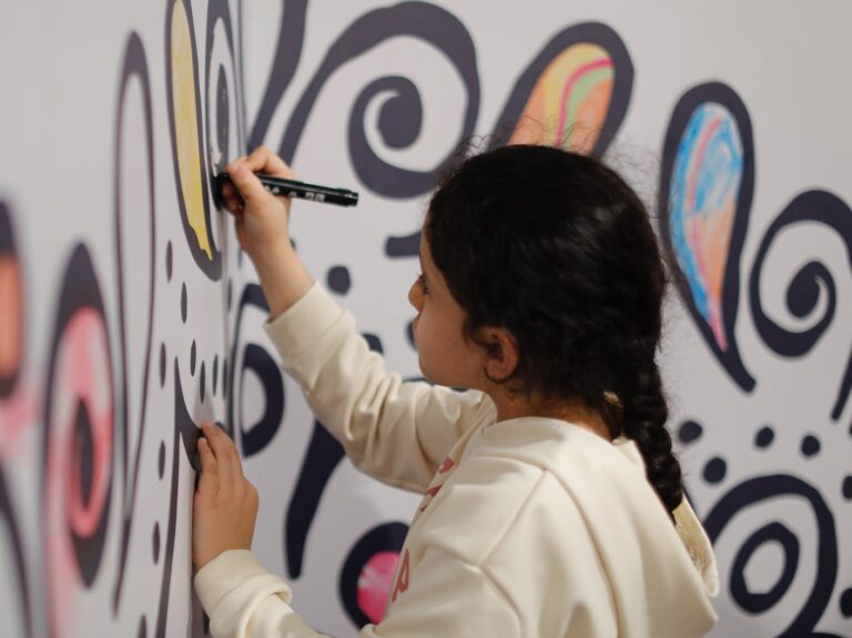 girl drawing on wall
