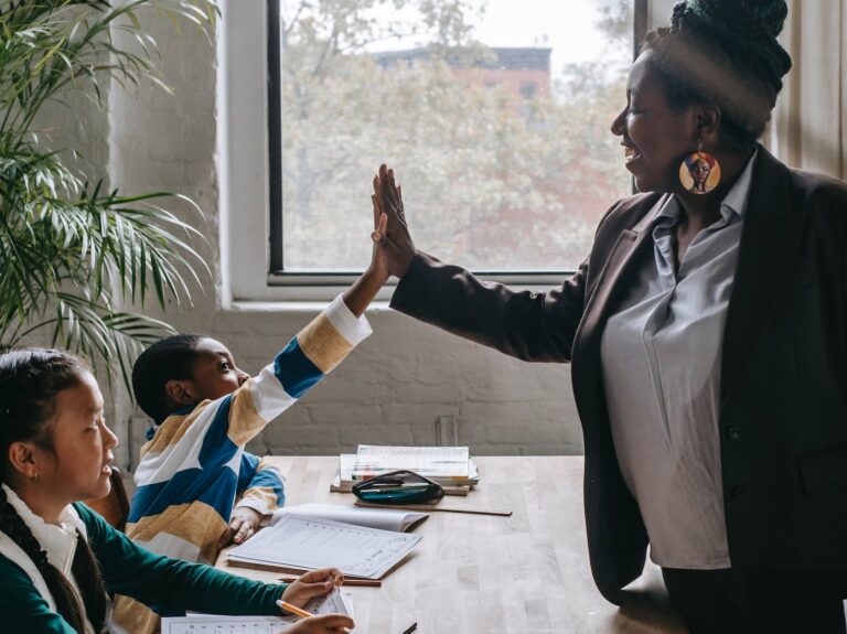 cheerful black teacher with diverse schoolkids