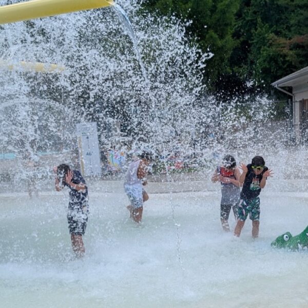 Kids get sprayed at water park.