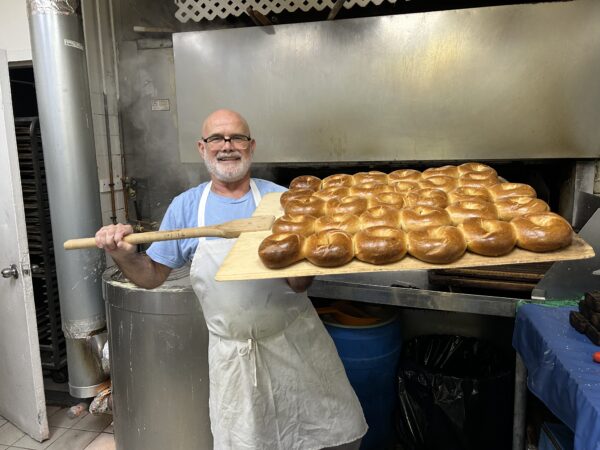 bagel baker with tray of finished bagels